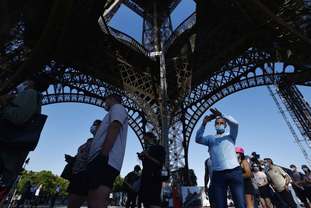 PHOTO: Visitors attend the reopening day of the Eiffel Tower in Paris, June 25, 2020.