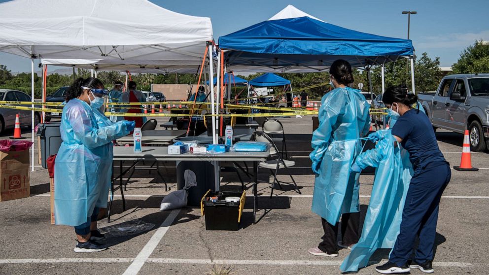 PHOTO: Nurses prepare themselves for coronavirus testing at a newly opened mega drive-thru testing site at El Paso Community College Valle Verde campus on July 21, 2020 in El Paso, Texas.