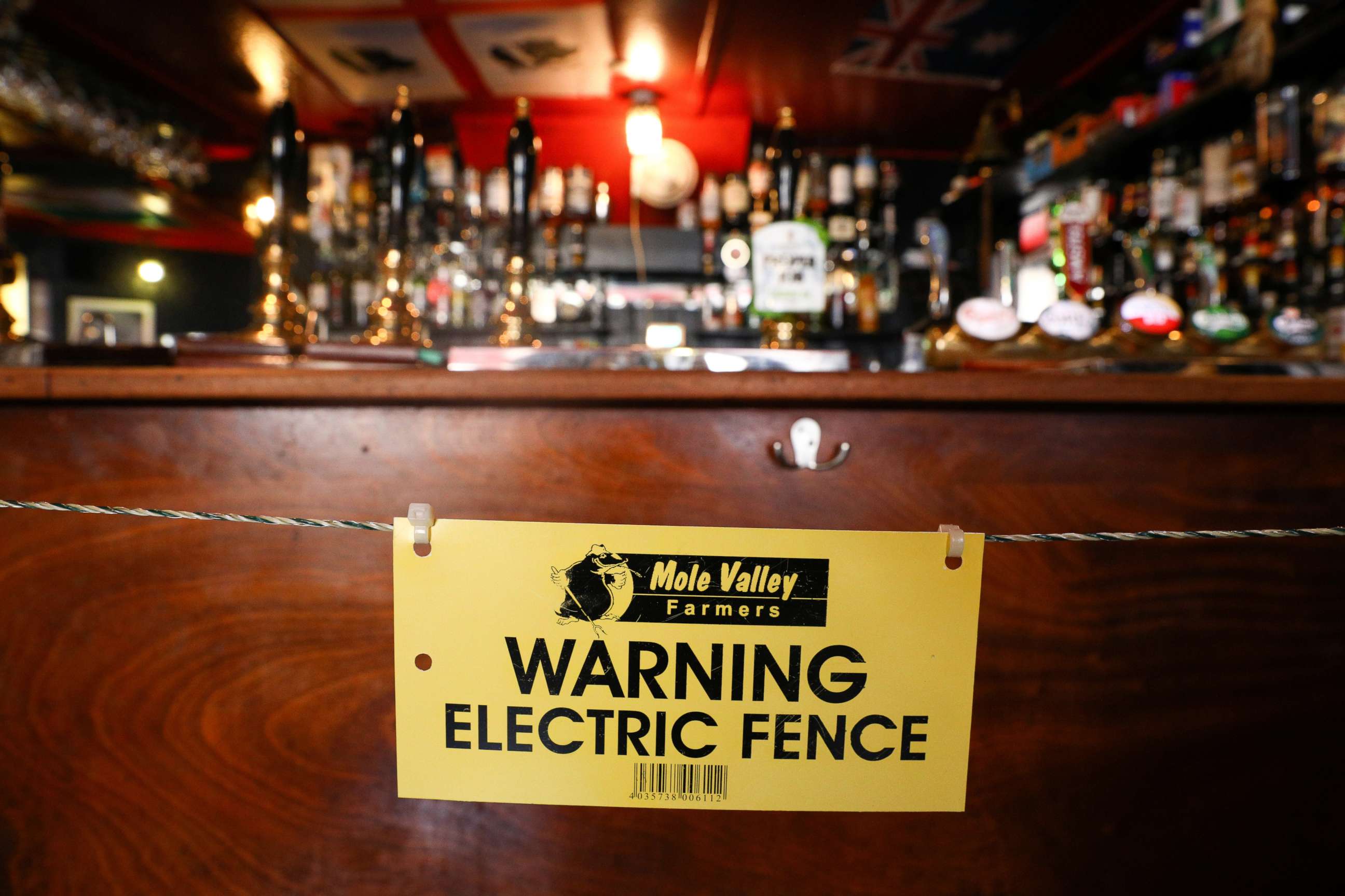 PHOTO: An electric fence installed at the bar area of The Star Inn, to ensure customers are socially distanced from staff while ordering drinks, following the outbreak of the coronavirus disease (COVID-19), in Cornwall, Britain July 14, 2020.