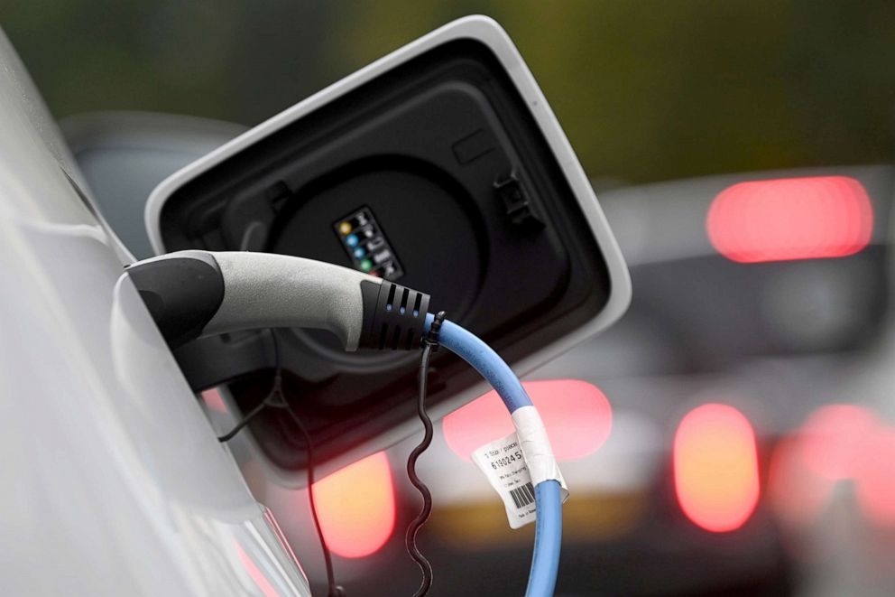 PHOTO: An electric car is charged at a roadside EV charge point, London, Oct. 19, 2021.