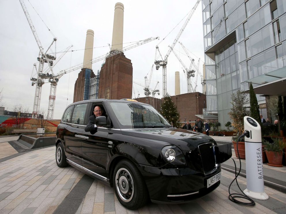 PHOTO: CEO of London EV Company, Chris Gubbey poses inside the new electric TX eCity taxi connected to a sample electric vehicle charger at the Battersea power station in London, Dec. 5, 2017.