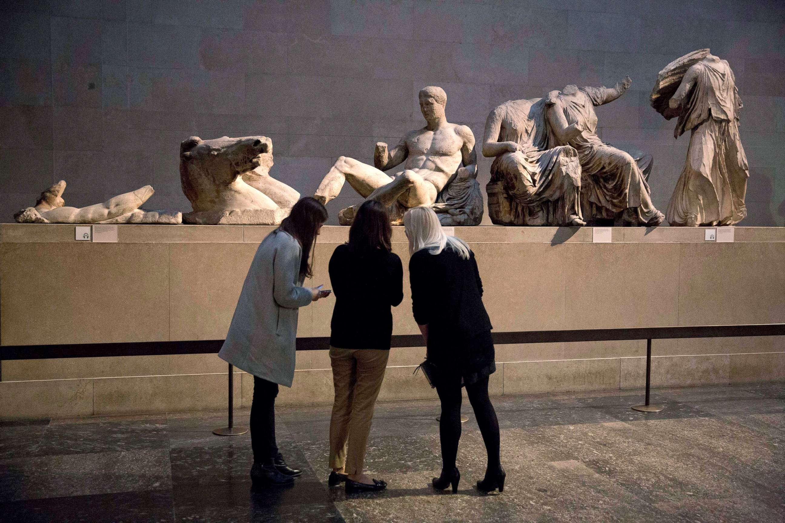 PHOTO: Visitors look at the marble statues from the east pediment of the Parthenon, on display at the British Museum in London, Jan. 8, 2015.