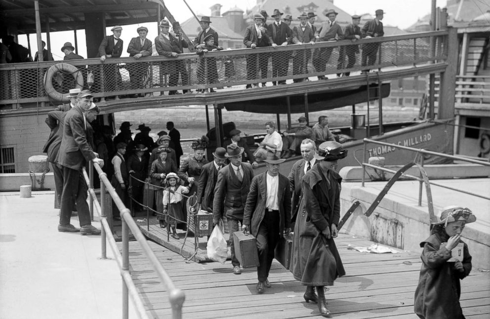 PHOTO: Newly arrived immigrants disembark from the passenger steamer Thomas C. Millard upon their arrival at Ellis Island, in New York, cicra 1905.