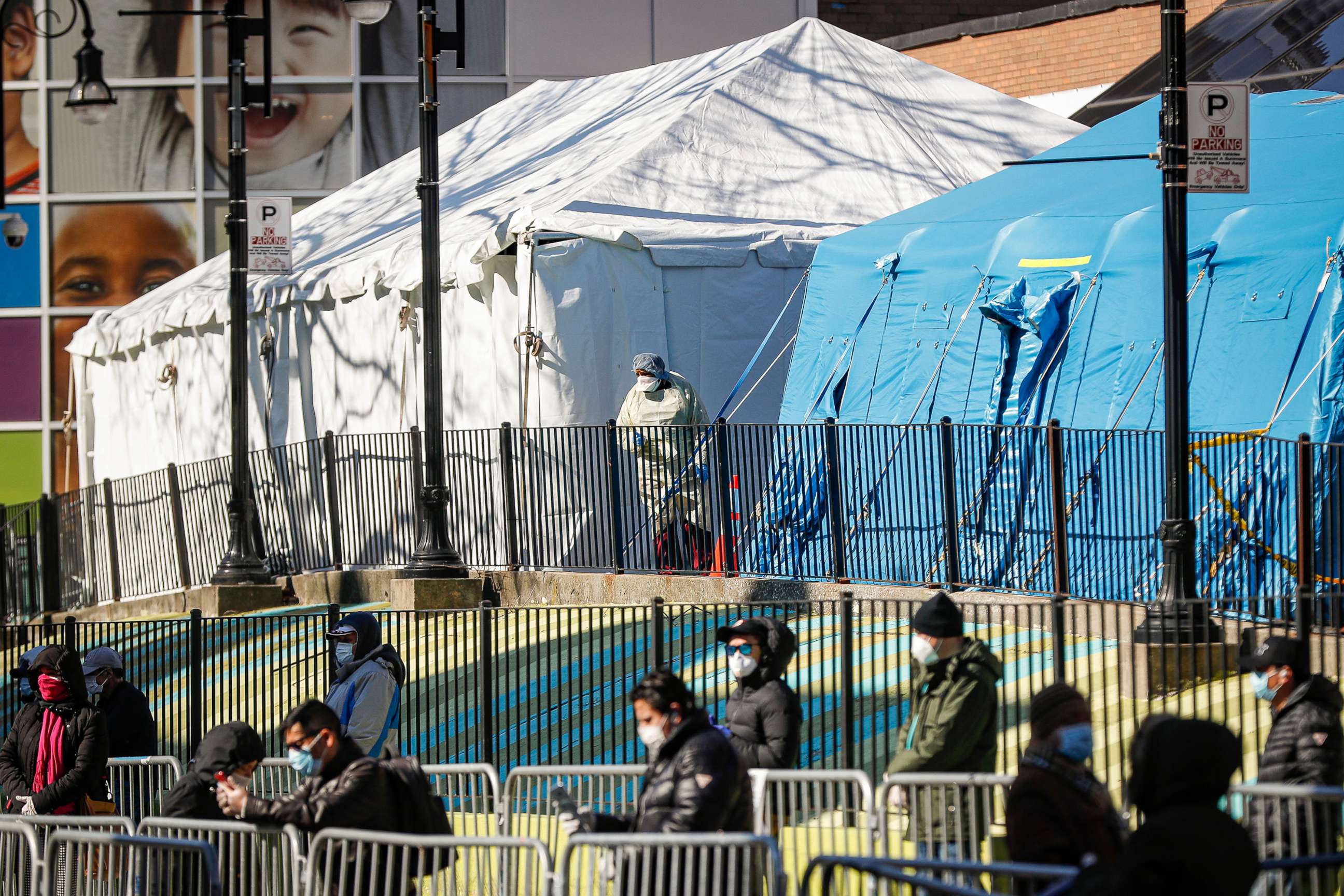 PHOTO: A medical worker looks out onto a line of patients waiting for COVID-19 testing outside Elmhurst Hospital Center, March 27, 2020, in New York during the coronavirus pandemic.