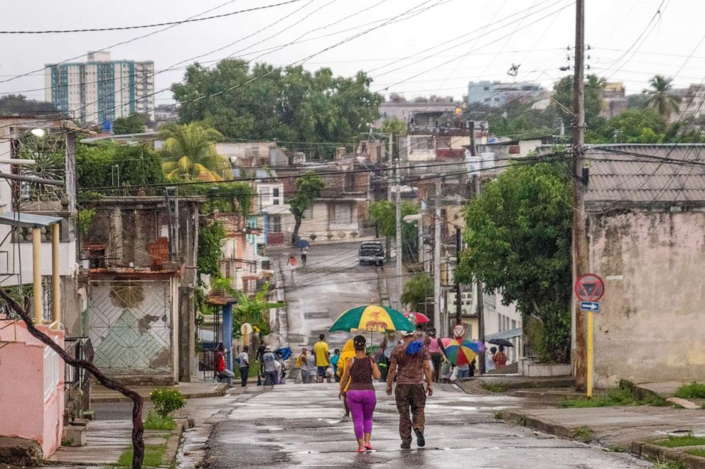 PHOTO: People gather outdoors in Santiago de Cuba, July 4, 2021, after the danger of hurricane Elsa had passed. The eye of hurricane Elsa passed about 200 kms from the city, causing medium rainfall.