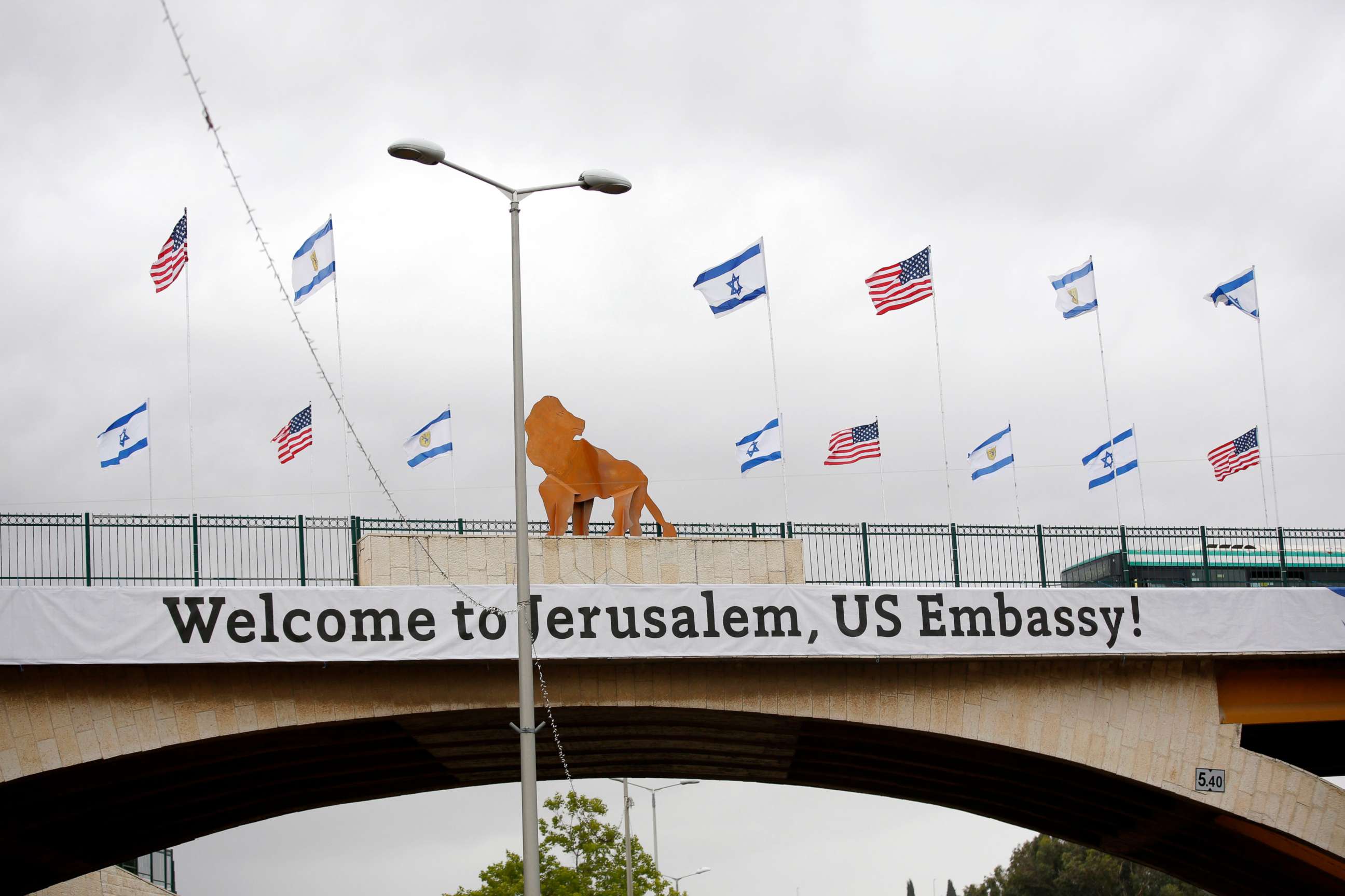 PHOTO: A sign and flags appear on a bridge nearby the US consulate that will act as the new US embassy in the Jewish neighborhood of Arnona, May 13, 2018.