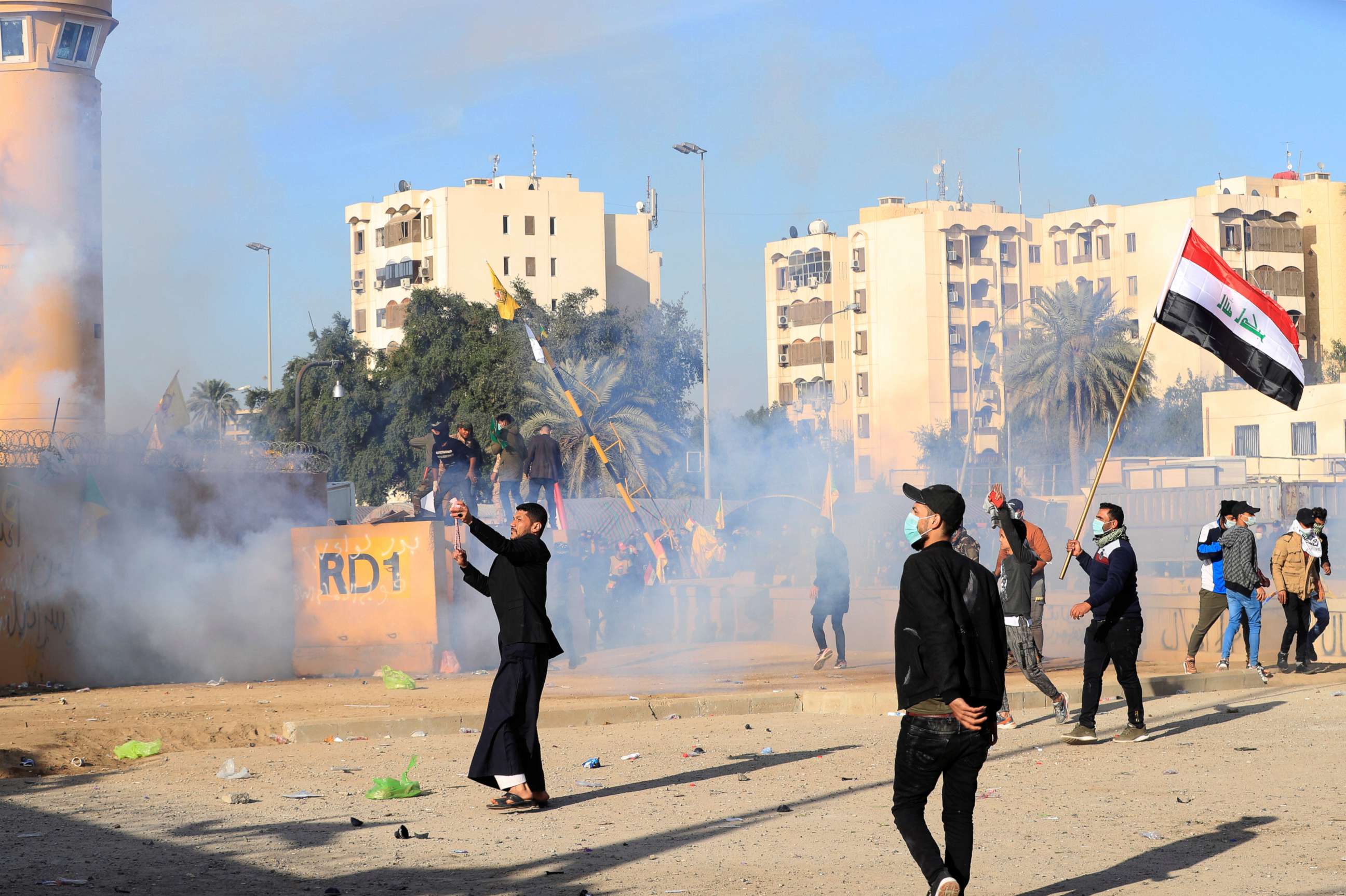 PHOTO: U.S. Embassy security men use tear gas to disperse protesters and militia fighters during a protest to condemn air strikes on bases belonging to Hashd al-Shaabi (paramilitary forces), outside the U.S. Embassy in Baghdad, Iraq January 1, 2020. 