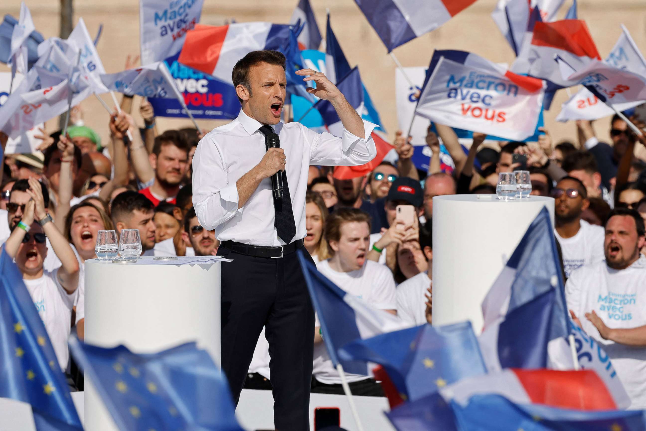 PHOTO: France's President and candidate for re-election Emmanuel Macron, surrounded by supporters, speaks during an election campaign meeting in Marseille, France on April 16, 2022, ahead of the second round of voting in France's presidential election.
