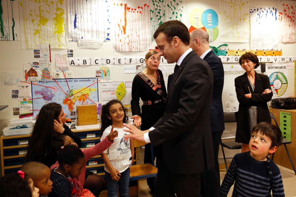 PHOTO: French President Emmanuel Macron speaks to pre-school children as he visits the Emelie pre-school in Paris, March 27, 2018.