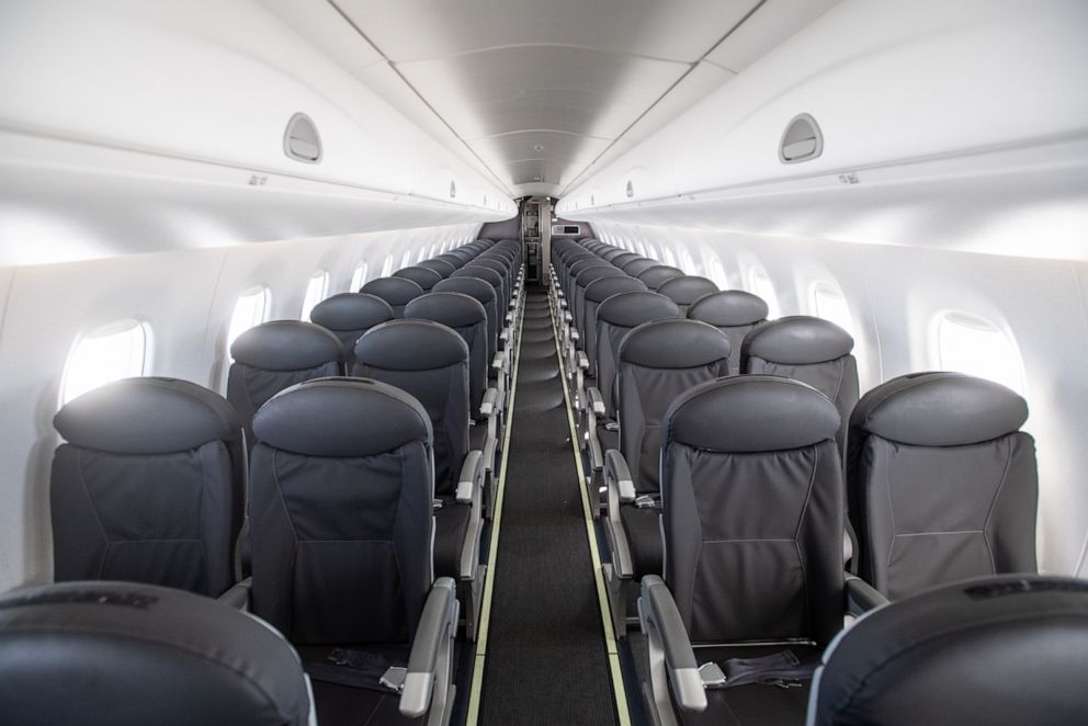 PHOTO: An almost empty British Airways passenger plane flies from Milan to London on March 5, 2020, in Milan, Italy.