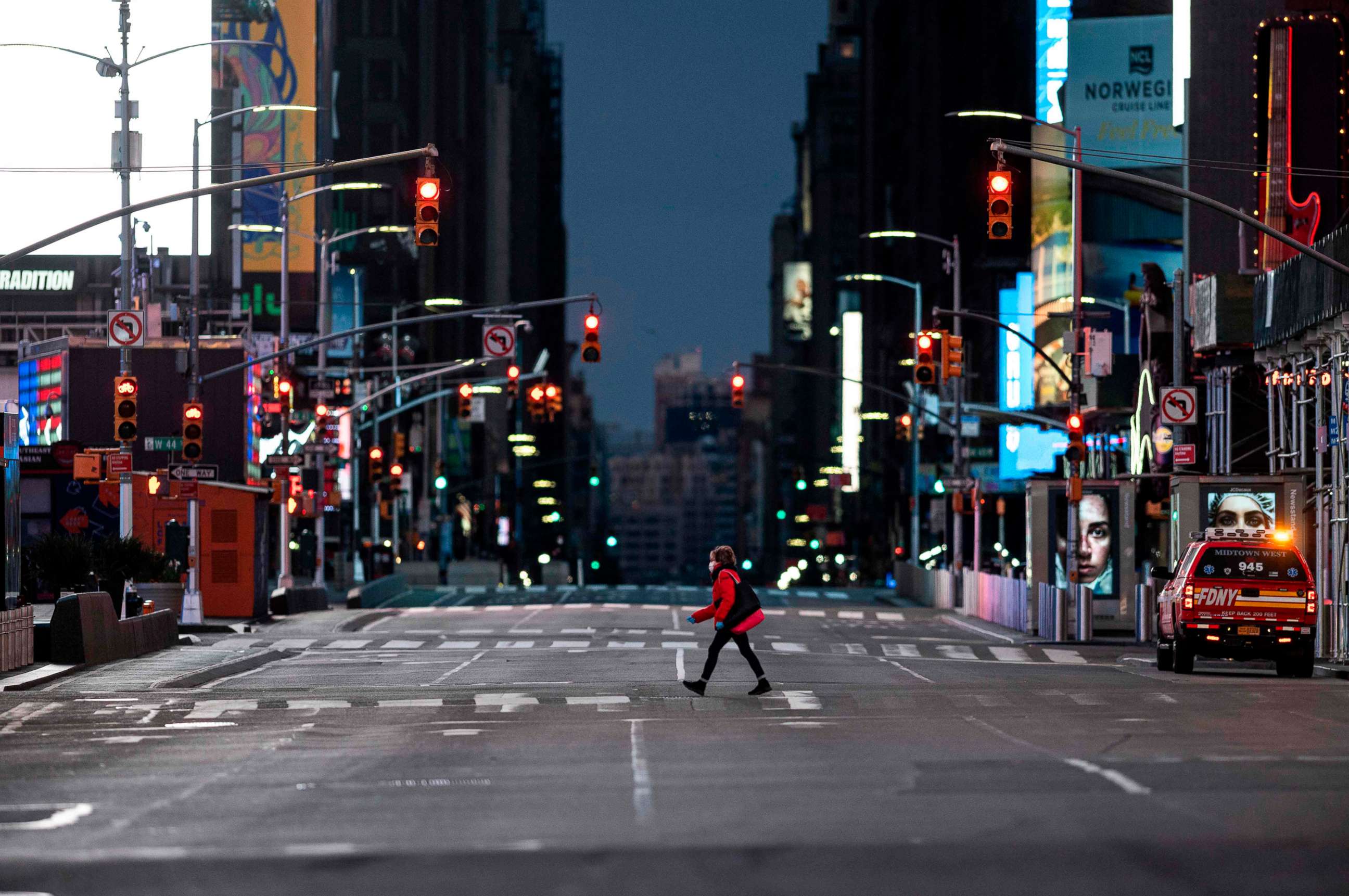 PHOTO: A woman walks through an almost-deserted Times Square in the early morning hours, on April 23, 2020, in New York City.