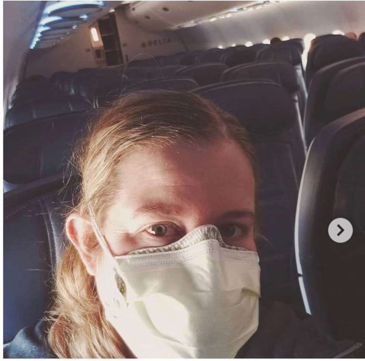 PHOTO: A nurse sits alone on a plane to New York on April 19, 2020.