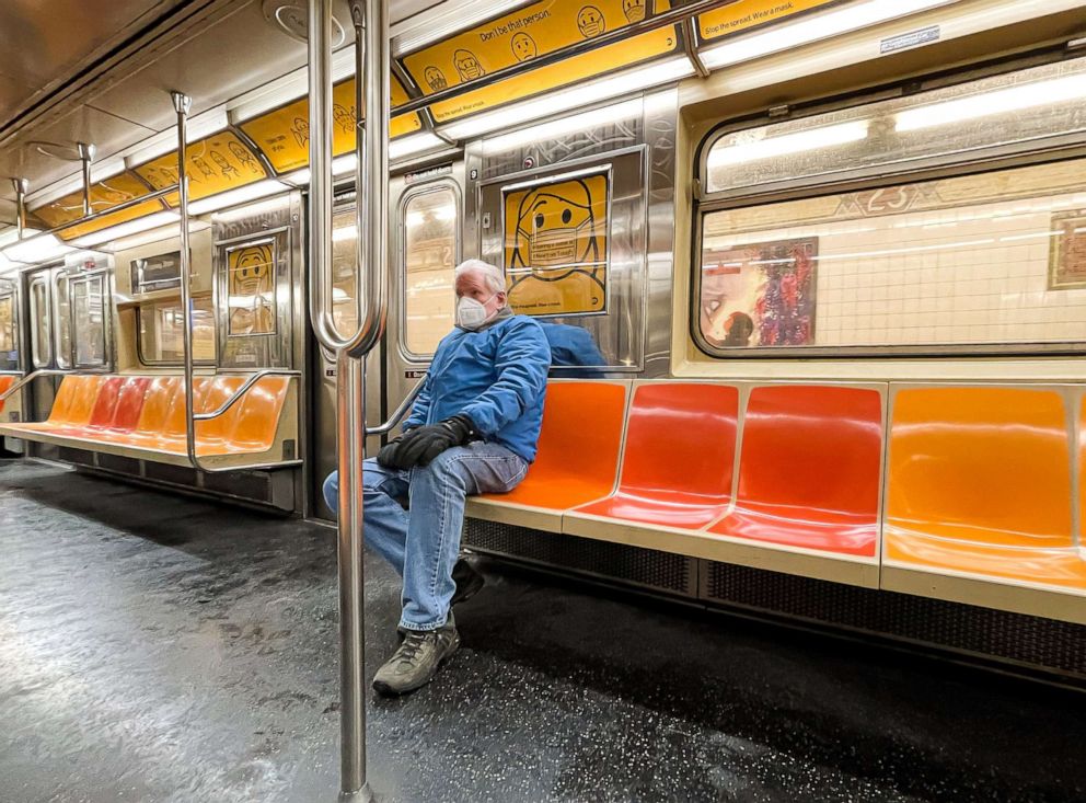 PHOTO: A person wears a face mask on an almost empty subway car on Dec. 18, 2020 in New York City.