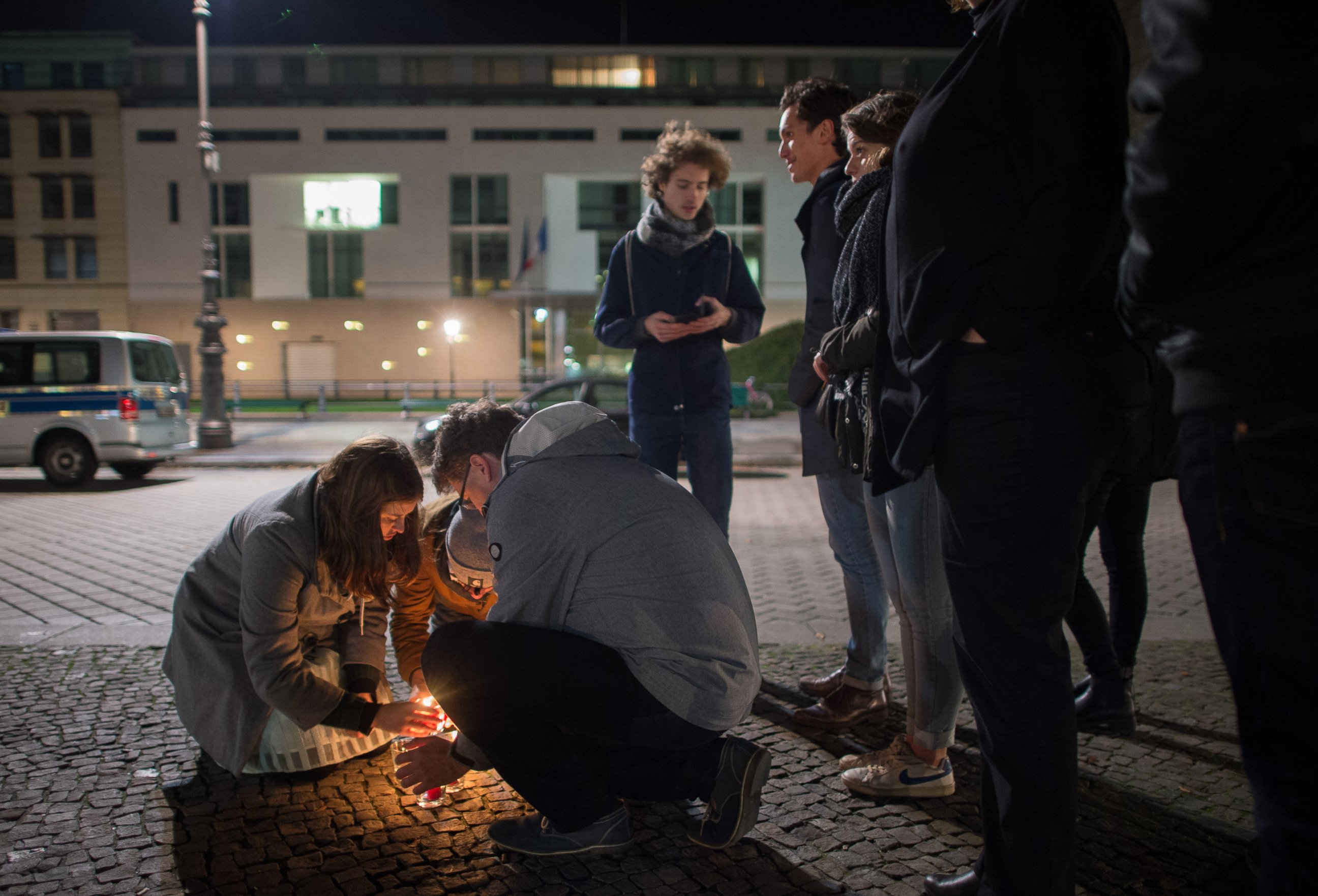 PHOTO: People light candles in tribute to the victims of the Paris attacks outside the French embassy in Berlin on Nov. 13, 2015.