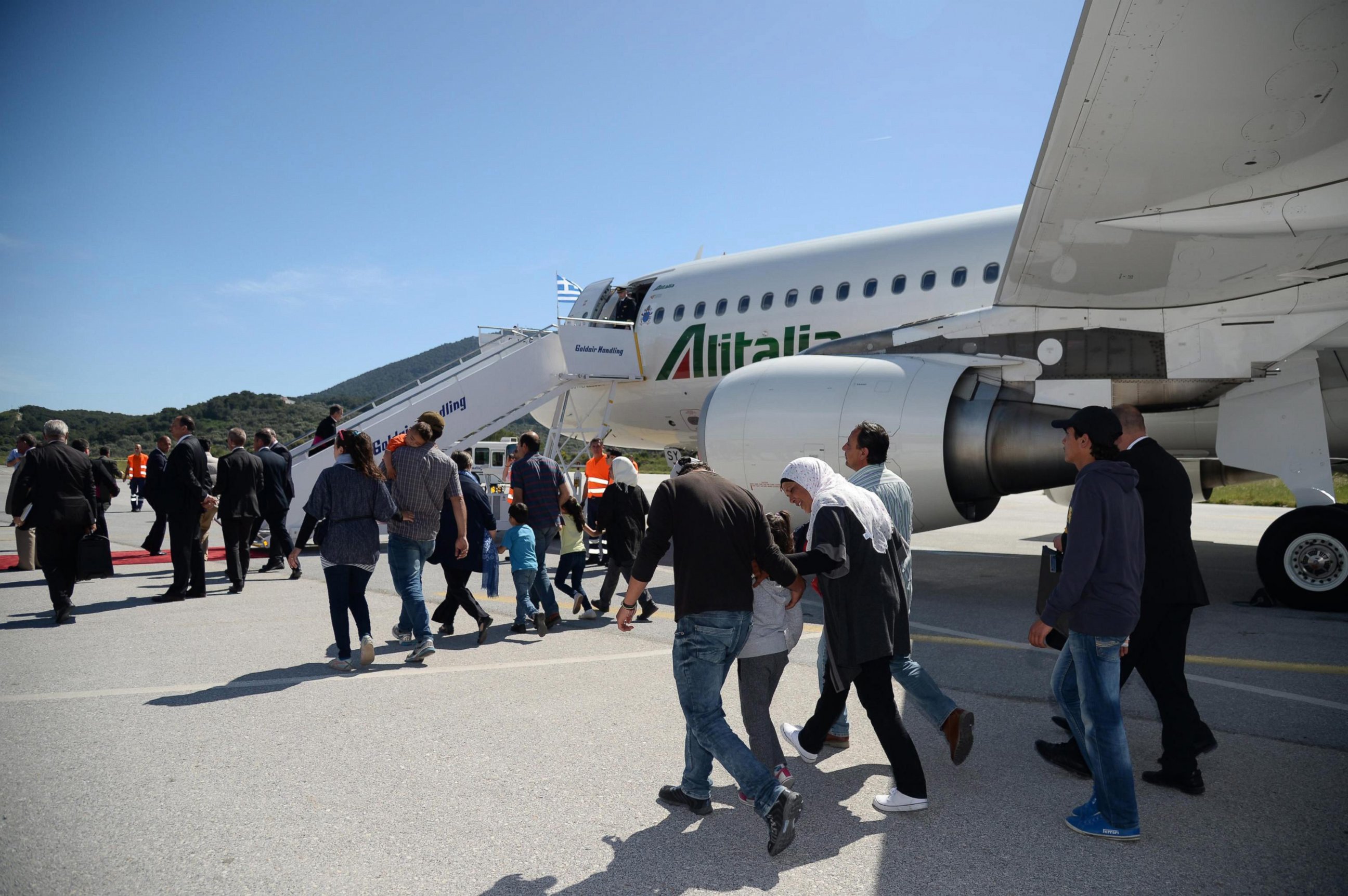 PHOTO: Syrian refugees board a plane with Pope Francis at the airport of Mytilene, on the island of Lesbos, Greece, April 16, 2016.