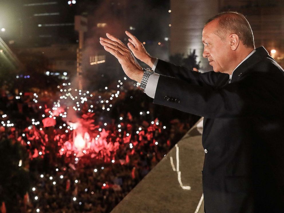 PHOTO: Turkish President Tayyip Erdogan waves to supporters gathered above a balcony at the headquarters of the AK Party in Ankara, June 24, 2018, as they celebrate Erdogan winning five more years in office.