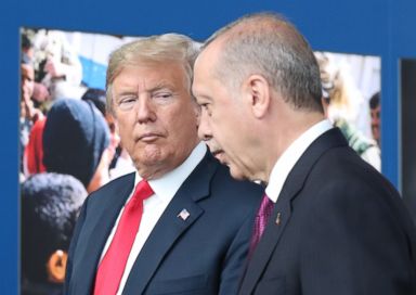 PHOTO: President Donald Trump talks to Turkeys President Recep Tayyip Erdogan as they arrive for the NATO summit in Brussels, July 11, 2018.