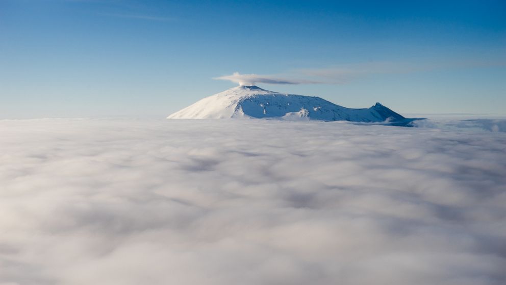 PHOTO: Mount Erebus emerges from the clouds, Dec. 10, 2016, in Antarctica. Erebus is the southernmost active volcano in the world.