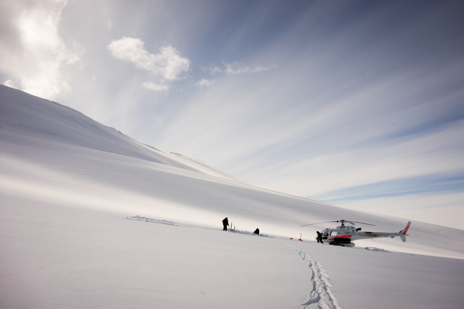 PHOTO: Dr. Graham Hill and Dr. Virginie Maris install a geophysics sensor on the flanks of Mt. Terror in Antarctica. 