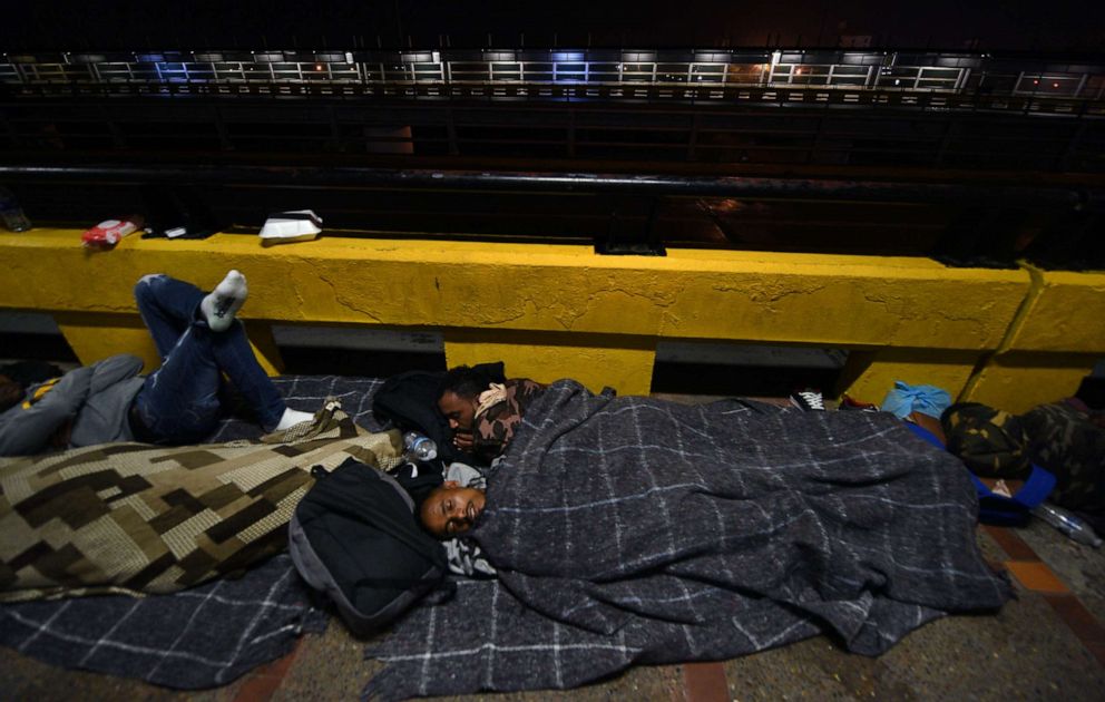 PHOTO: Immigrants from Eritrea wait on bridge in Matamoros, Mexico near the U.S. border, July 2, 2018. They spent 3 months on the journey through Brazil to reach the U.S. where they were eventually allowed in to be processed for credible fear.