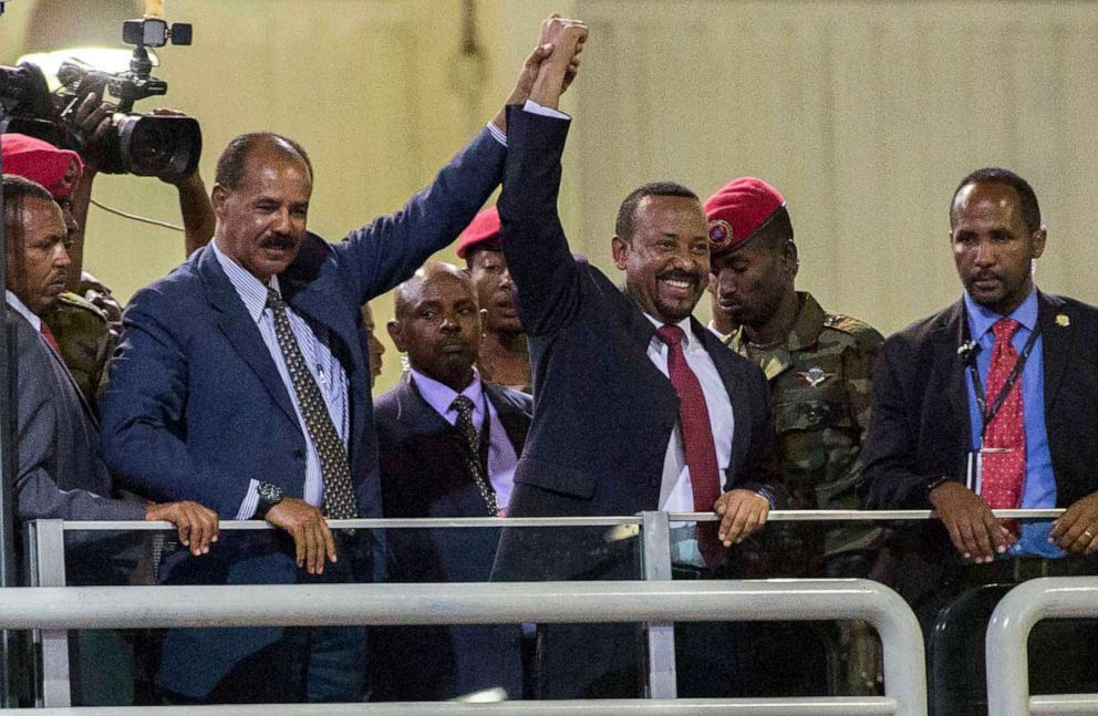 PHOTO: In this July 15, 2018 file photo, Eritrean President Isaias Afwerki and Ethiopian Prime Minister Abiy Ahmed hold hands as they wave at the crowds in Addis Ababa, Ethiopia.