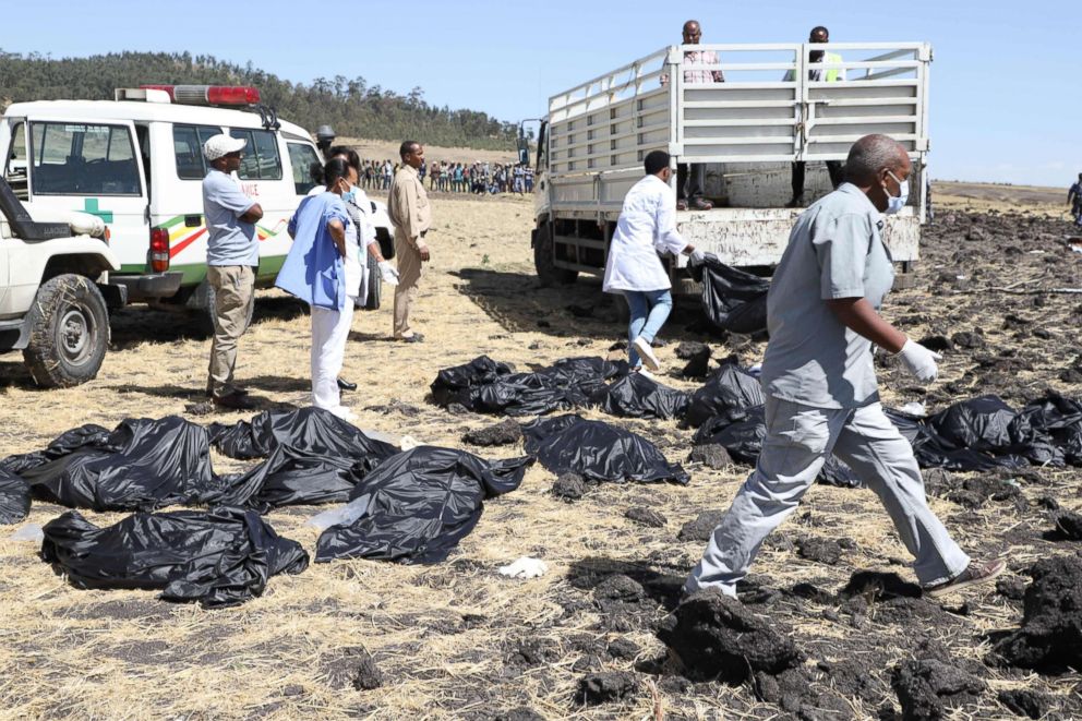 PHOTO: Rescue teams walk past collected bodies in bags at the crash site of Ethiopia Airlines near Bishoftu, southeast of Addis Ababa, Ethiopia, March 10, 2019. 