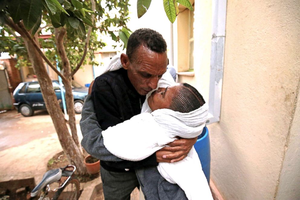 PHOTO: Addisalem Hadgu embraces his wife, Nitslal Abraha for the first time in eighteen years, in Asmara Eritrea, July 19, 2018.