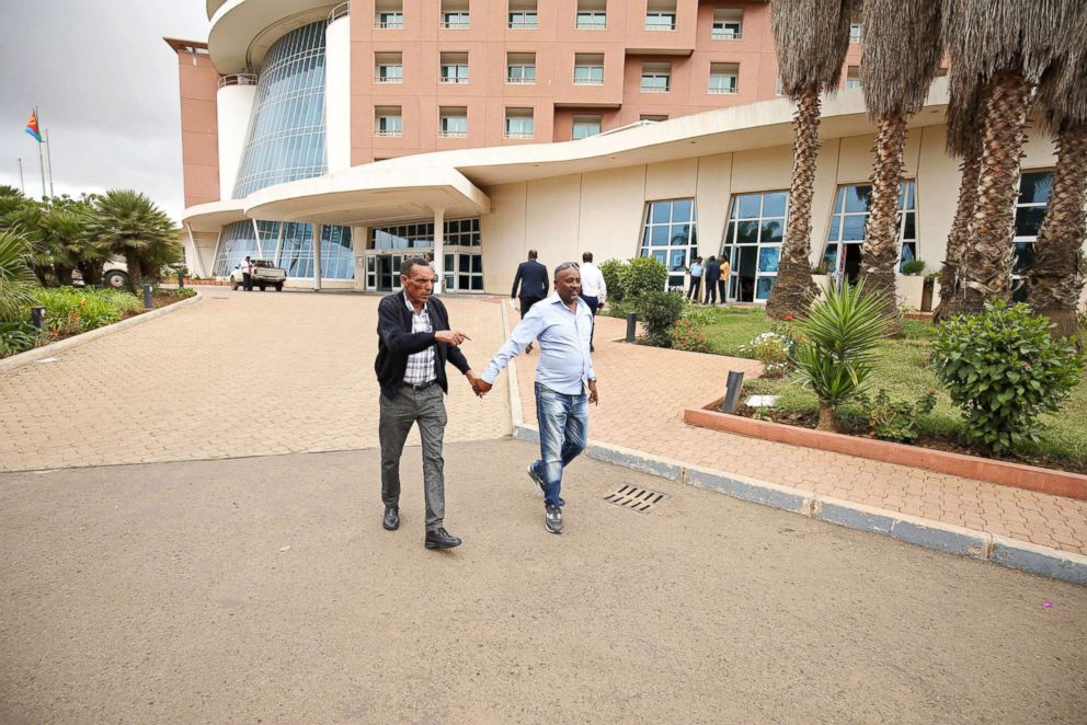 PHOTO: Addisalem Hadgu, 58, an Ethiopian state TV journalist, meets his brother-in-law, Solomon Yemane, 48, a member of the Eritrean military, in front of his hotel after arriving in Asmara to meet his family in Asmara, Eritrea, July 19, 2018.
