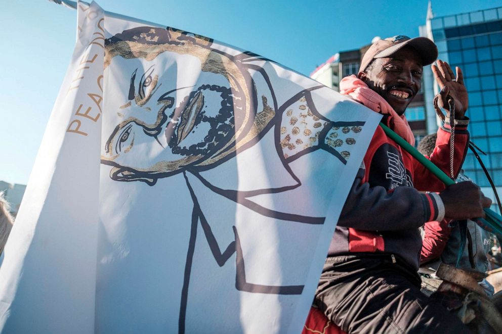 PHOTO: A horseman holds a flag depicting Ethiopian Prime Minister Abiy Ahmed as a crowd prepares in Addis Ababa to welcome him after he received the Nobel Peace Prize in Oslo, on Dec. 12, 2019.