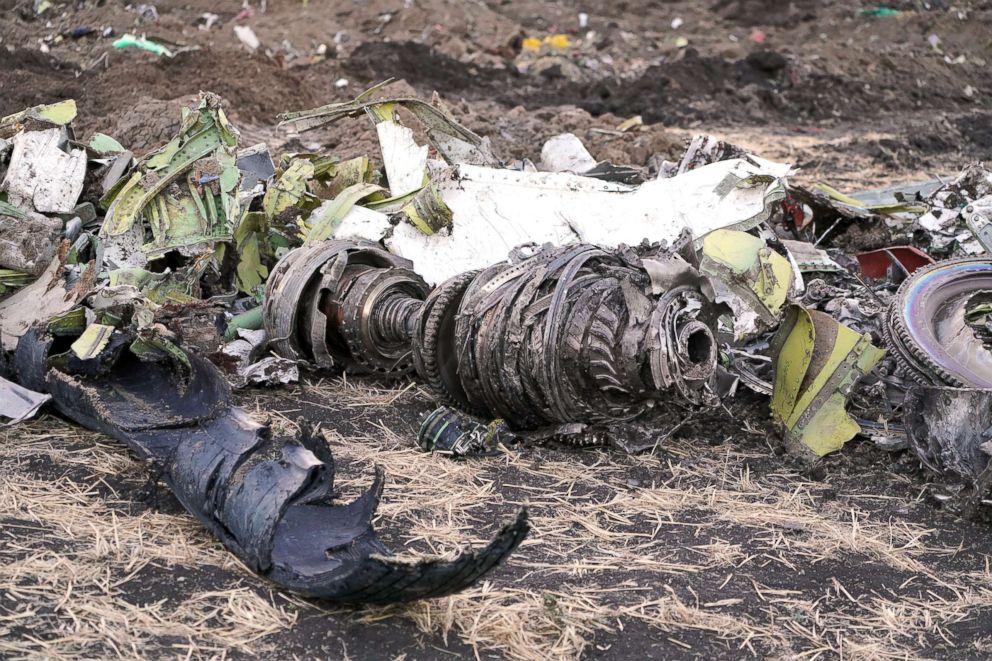 PHOTO: Parts of an engine and landing gear lie in a pile after being gathered by workers during the continuing recovery efforts at the crash site of Ethiopian Airlines flight ET302 on March 11, 2019 in Bishoftu, Ethiopia.