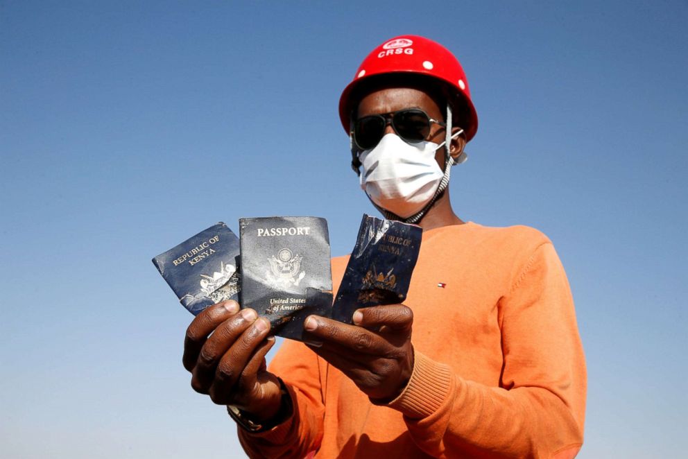 PHOTO: A man holds passengers' passports found at the scene of the Ethiopian Airlines Flight ET 302 plane crash, near the town of Bishoftu, Ethiopia, March 12, 2019.