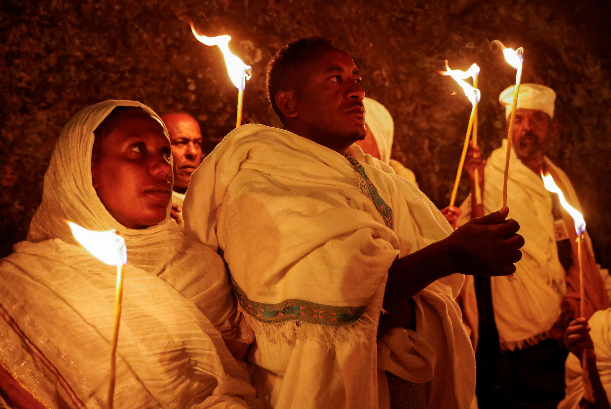 PHOTO: Ethiopian Orthodox pilgrims hold candle during the Christmas celebration in Bete Mariam -- House of Mary -- monolithic Orthodox church in Lalibela, Ethiopia, on Jan. 7, 2023.