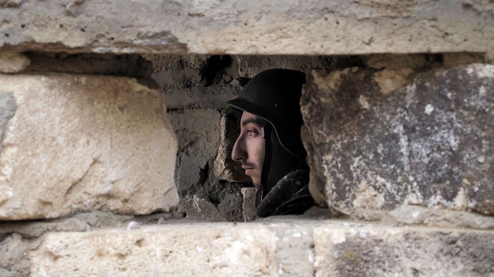 PHOTO: An Ethnic Armenian soldier is seen inside a dugout at a fighting position on the front line, during a military conflict against Azerbaijan's armed forces in the separatist region of Nagorno-Karabakh, Oct. 21, 2020.