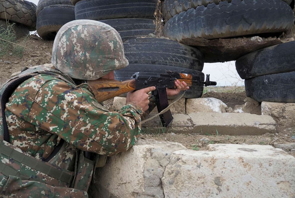 PHOTO: An Ethnic Armenian soldier holds a machine gun as he looks toward Azerbaijan's positions from a dugout on the front line, during a military conflict against Azerbaijan's armed forces in the separatist region of Nagorno-Karabakh, Oct. 21, 2020.