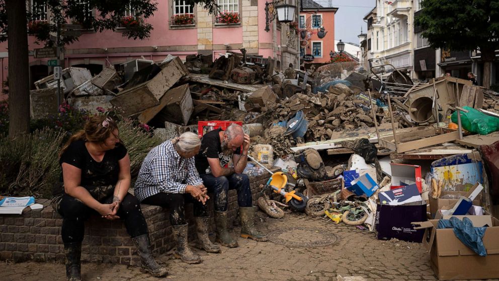PHOTO: People rest from cleaning up the debris of the flood disaster in Bad Neuenahr-Ahrweiler, Germany, July 19, 2021.