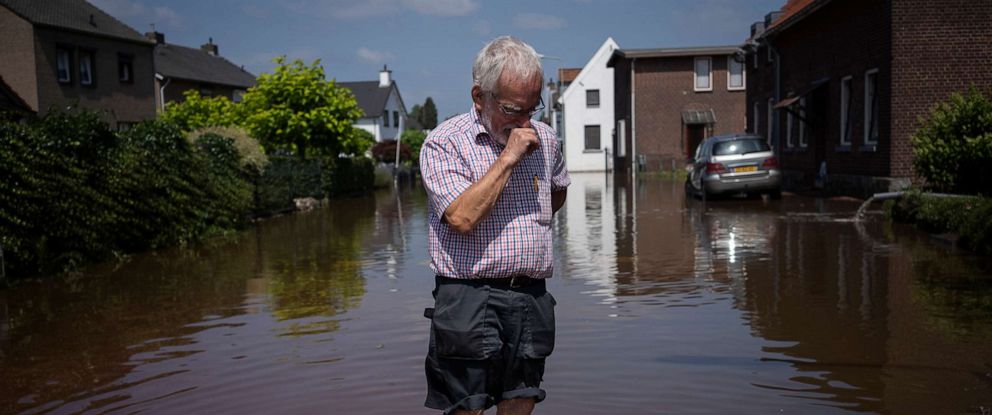 PHOTO: Wiel de Bie, 75, stands outside his flooded home in the town of Brommelen, Netherlands, July 17, 2021.