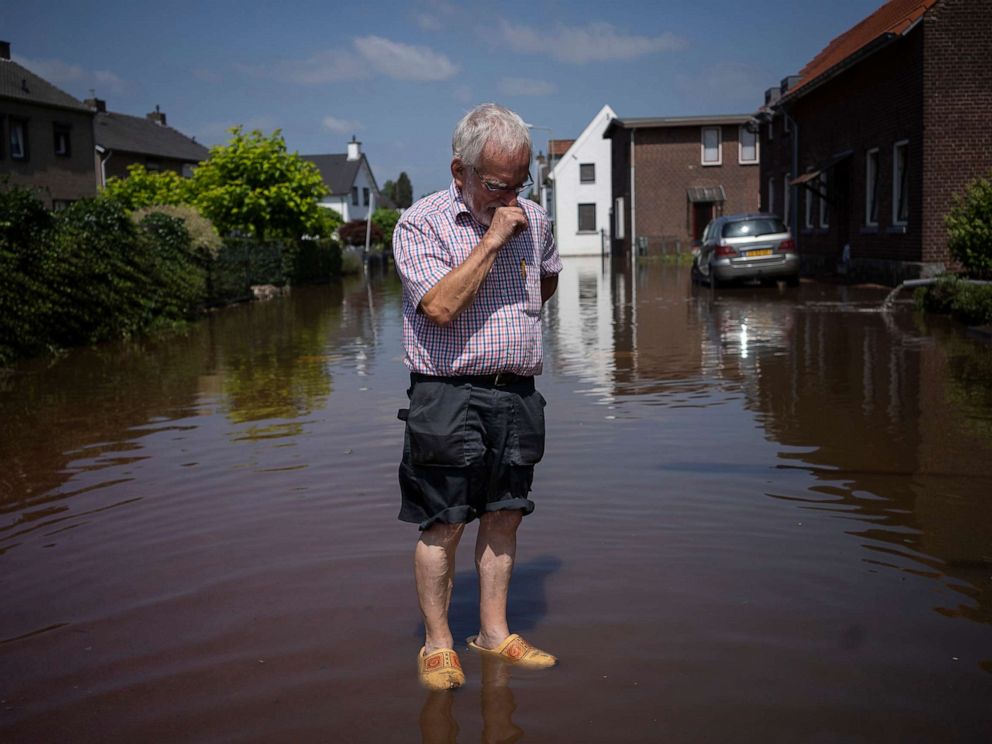 PHOTO: Wiel de Bie, 75, stands outside his flooded home in the town of Brommelen, Netherlands, July 17, 2021.