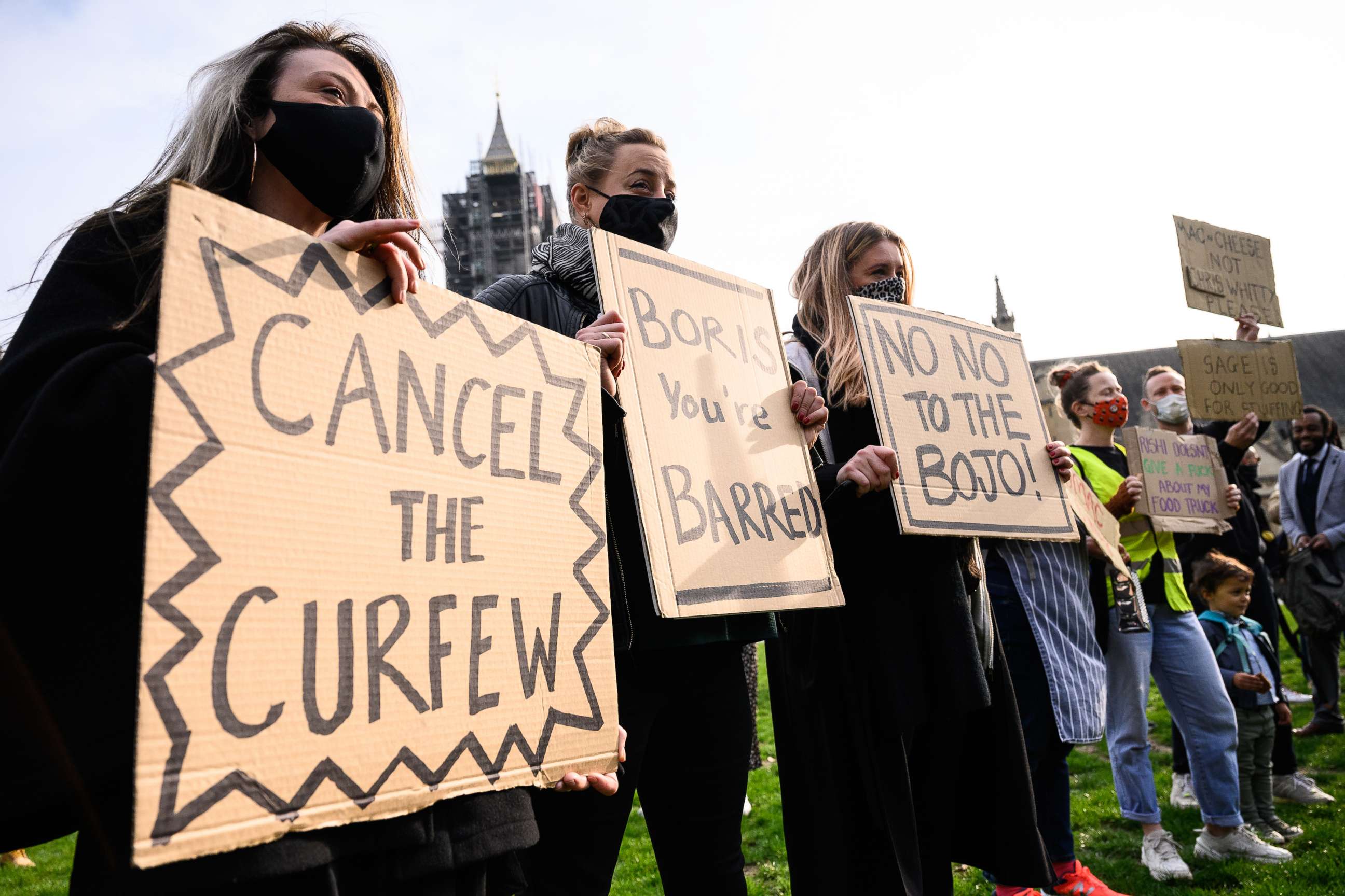PHOTO: LONDON, ENGLAND - OCTOBER 19: Workers from the hospitality sector hold placards as they take part in a demonstration at Parliament Square on October 19, 2020 in London, England.