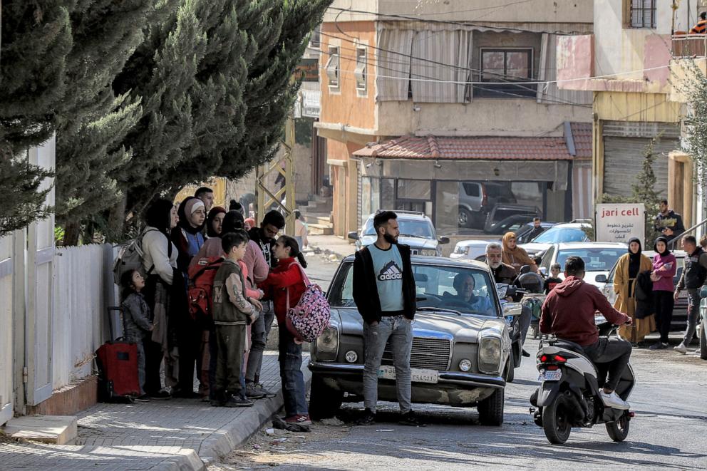 PHOTO: People wait along the side of a road for their ride before evacuating Lebanon's eastern city of Baalbek in the Bekaa Valley on Oct. 30, 2024, after a statement from the Israeli army spokesperson warning residents of incoming strikes 