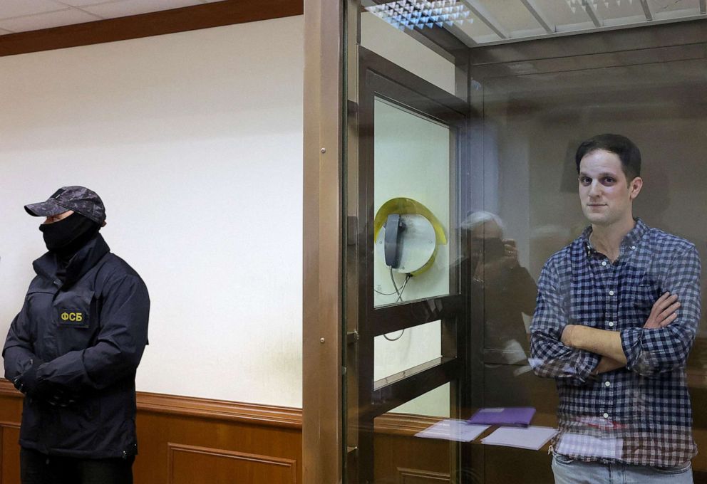 PHOTO: In this April 18, 2023, file photo, Wall Street Journal reporter Evan Gershkovich stands behind a glass wall of an enclosure for defendants before a court hearing to consider an appeal against his detention, in Moscow.