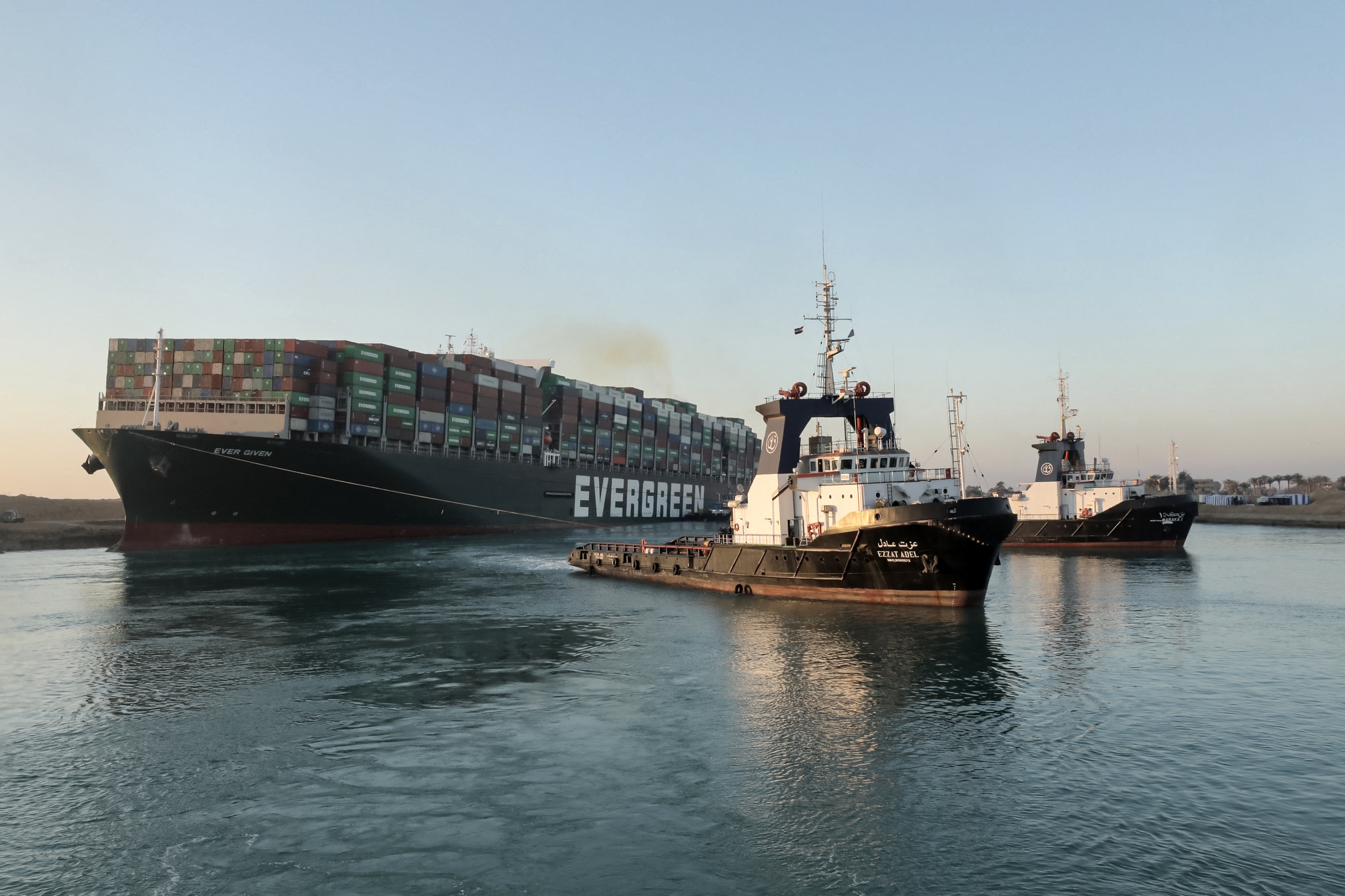 PHOTO: Tugboats are seen pulling the "Ever Given" container ship stuck sideways across Egypt's Suez Canal in this handout photo released by the Suez Canal Authority on March 29, 2021.