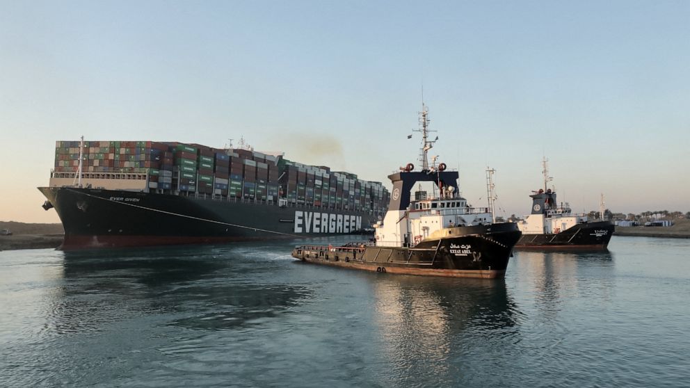 PHOTO: Tugboats are seen pulling the "Ever Given" container ship stuck sideways across Egypt's Suez Canal in this handout photo released by the Suez Canal Authority on March 29, 2021.