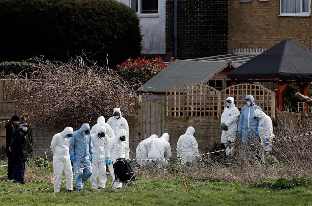 PHOTO: Police officers search an area of grass land behind a house, as the investigation into the disappearance of Sarah Everard continues, in Deal, Britain, March 12, 2021.