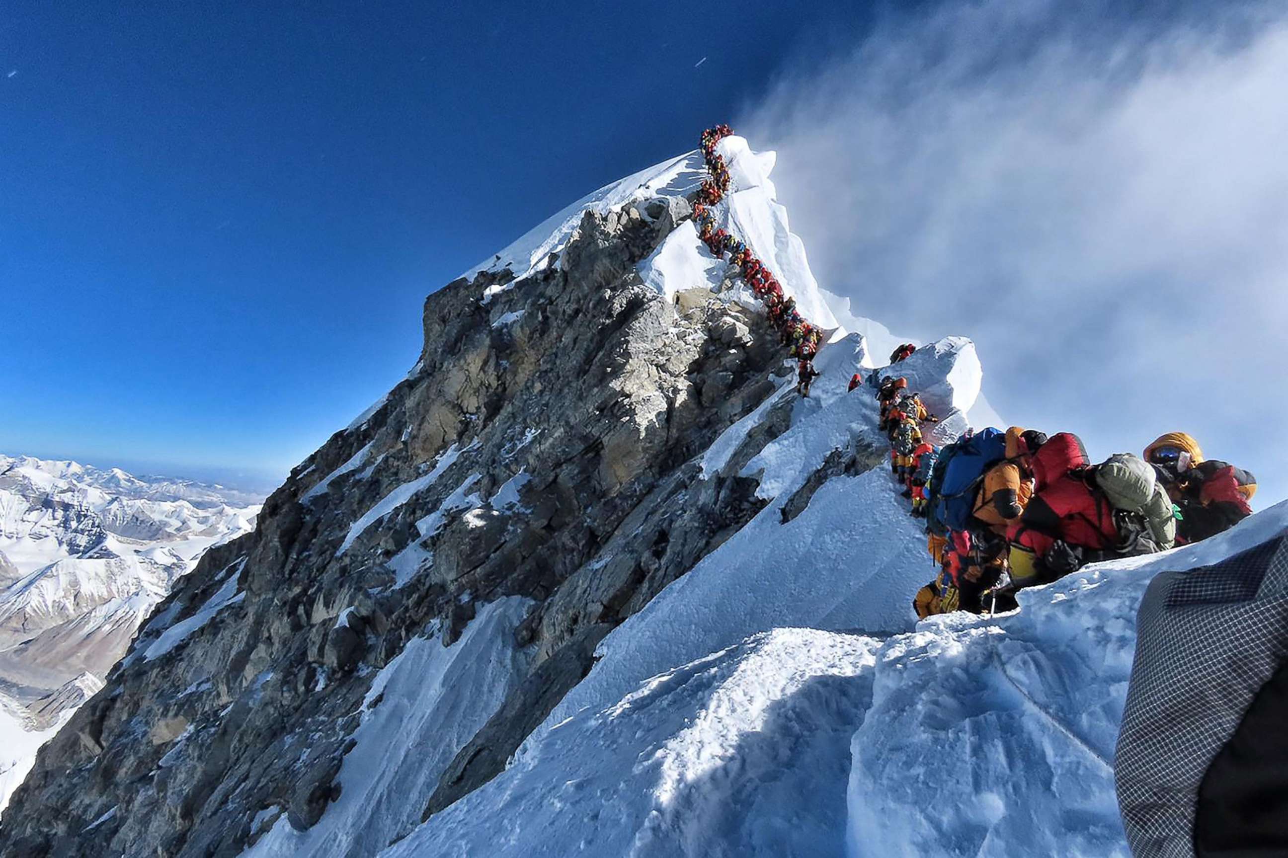 PHOTO: This handout photo taken on May 22, 2019 and released by climber Nirmal Purja's Project Possible expedition shows heavy traffic of mountain climbers lining up to stand at the summit of Mount Everest.