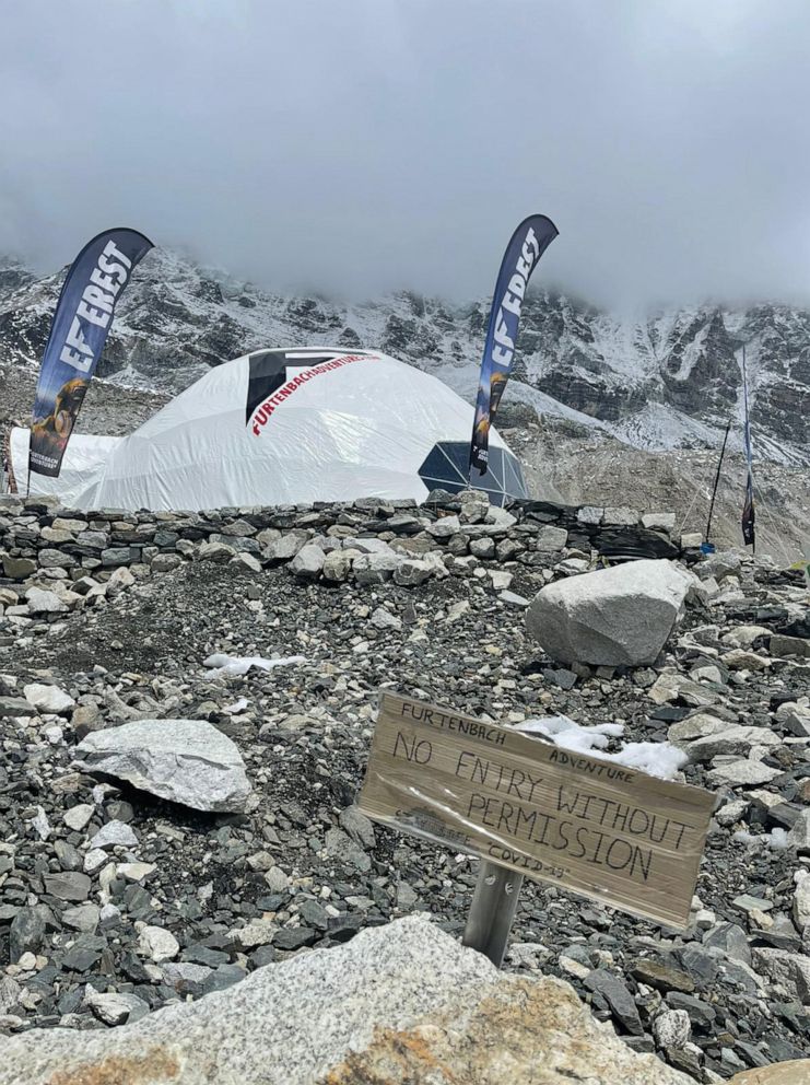 PHOTO: A Furtenbach Adventure camp on Mount Everest in May, 2021, with a sign saying "no entry without permission" and "stay safe 'COVID-10.'"