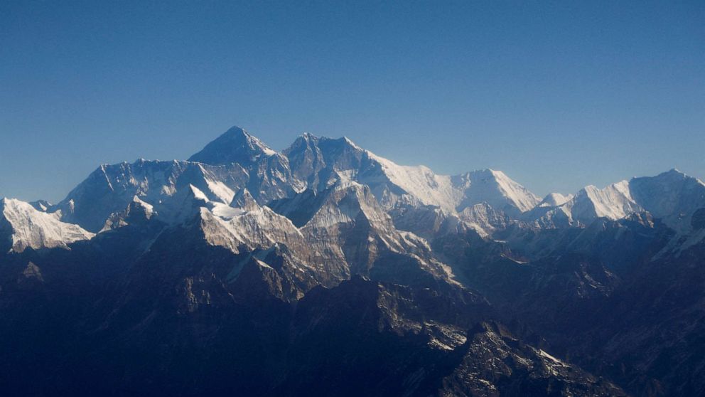 FILE PHOTO: Mount Everest, the world highest peak, and other peaks of the Himalayan range are seen through an aircraft window during a mountain flight from Kathmandu, Nepal January 15, 2020.