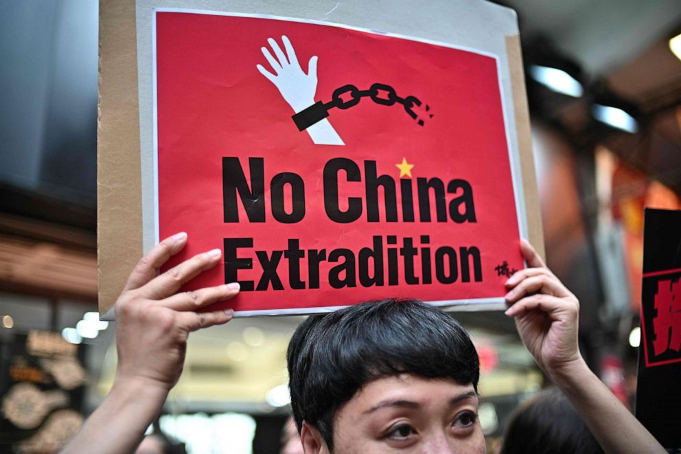 PHOTO: A demonstrator holds a placard during a protest in Hong Kong, April 28, 2019, against a controversial move by the government to allow extraditions to the Chinese mainland.