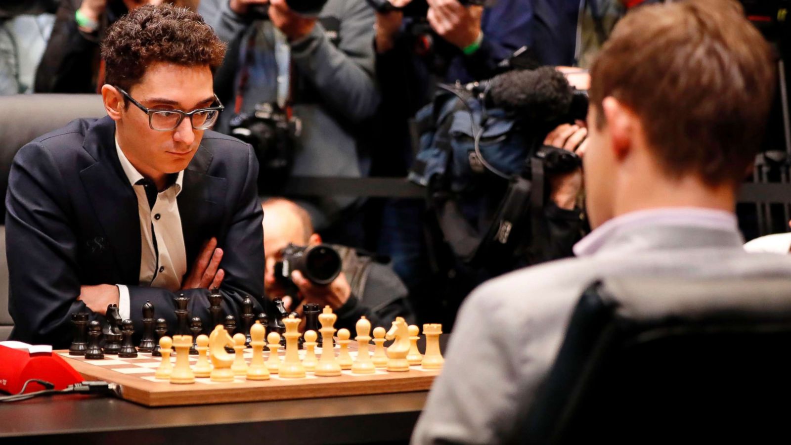 Reigning chess world champion Magnus Carlsen, right, from Norway, plays  Italian-American challenger Fabiano Caruana in the first five minutes of  round three of their World Chess Championship Match in London, Monday, Nov.