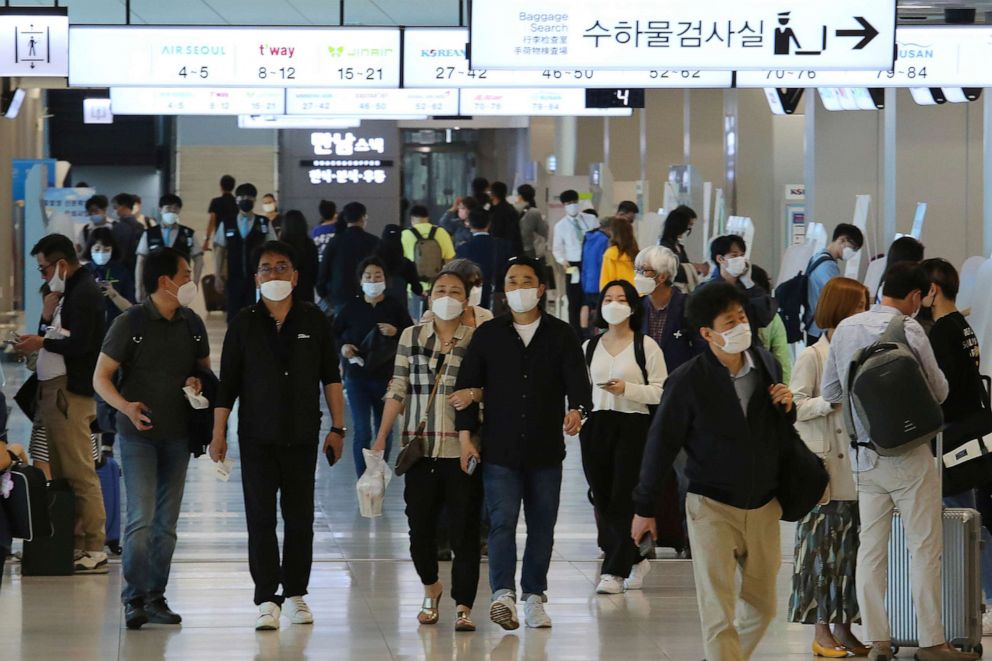 PHOTO: People wearing face masks arrive at the domestic flight terminal of Gimpo International Airport in Seoul, South Korea, on May 27, 2020. South Korean authorities now require all airplane passengers to wear masks amid the coronavirus pandemic.