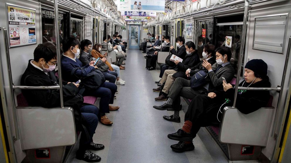PHOTO: People wearing face masks amid concerns over the spread of the novel coronavirus commute on a train in Tokyo, Japan, on April 6, 2020.